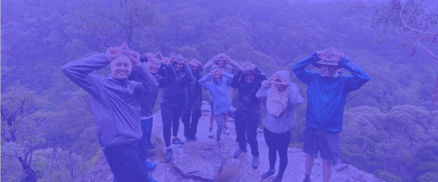 Atarix employees celebrating with 'A' symbol